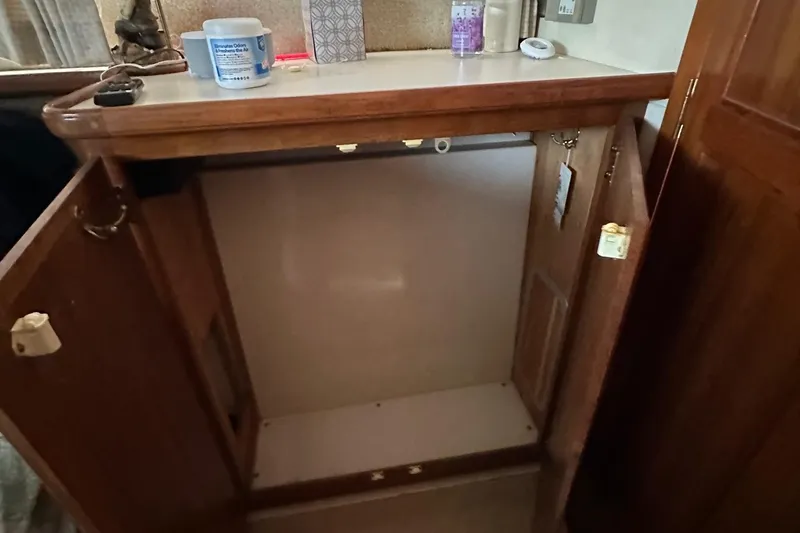 Slide: The Image of Open wooden cabinet in 1988 Carver 38 Aft Cabin boat interior. - 36