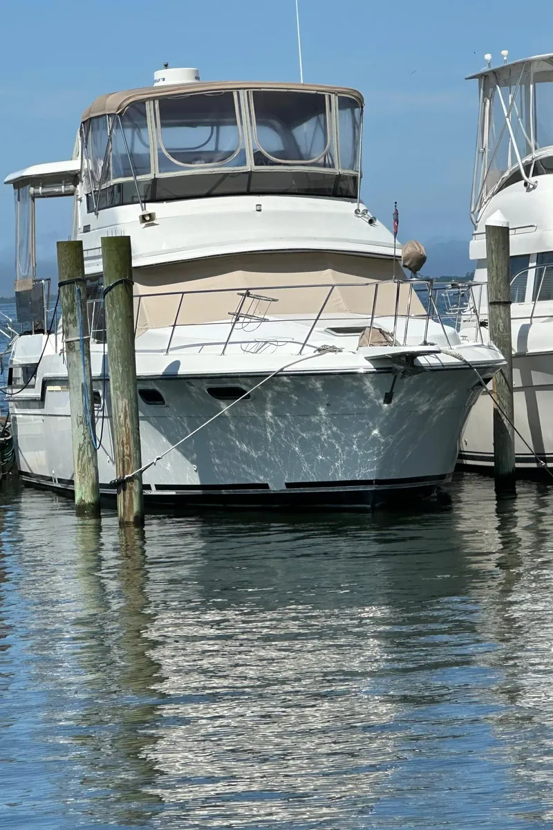 Slide: The Image of 1988 Carver 38 Aft Cabin yacht docked at marina, sunny day. - 5