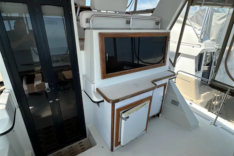Slide: The Image of 1988 Carver 38 Aft Cabin interior with wooden accents and glass doors. - 8