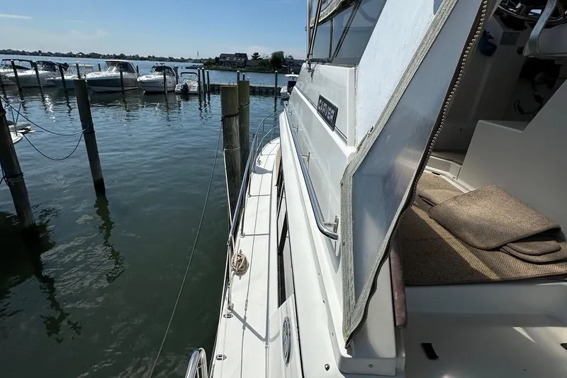 Slide: The Image of 1988 Carver 38 Aft Cabin yacht docked at marina, sunny day. - 9