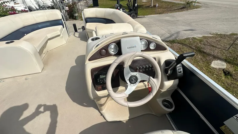 Slide: The Image of 2012 Xcursion X21C boat interior with steering wheel and seating area. - 3