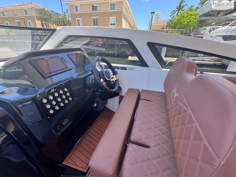 Slide: The Image of 2024 NX Boats 340 Sport Coupe interior with modern dashboard and luxurious seating. - 30