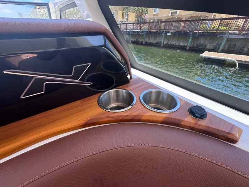 Slide: The Image of 2024 NX Boats 340 Sport Coupe interior with cup holders and sleek design. - 40