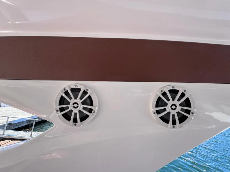 Slide: The Image of 2024 NX Boats 340 Sport Coupe speakers on sleek white hull. - 46