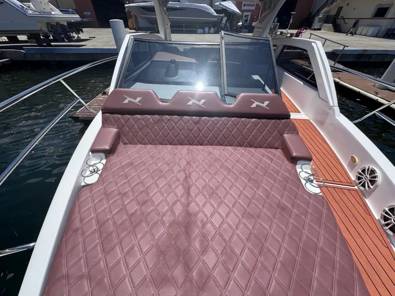 Slide: The Image of 2024 NX Boats 340 Sport Coupe with luxurious diamond-stitched seating and sleek design. - 47