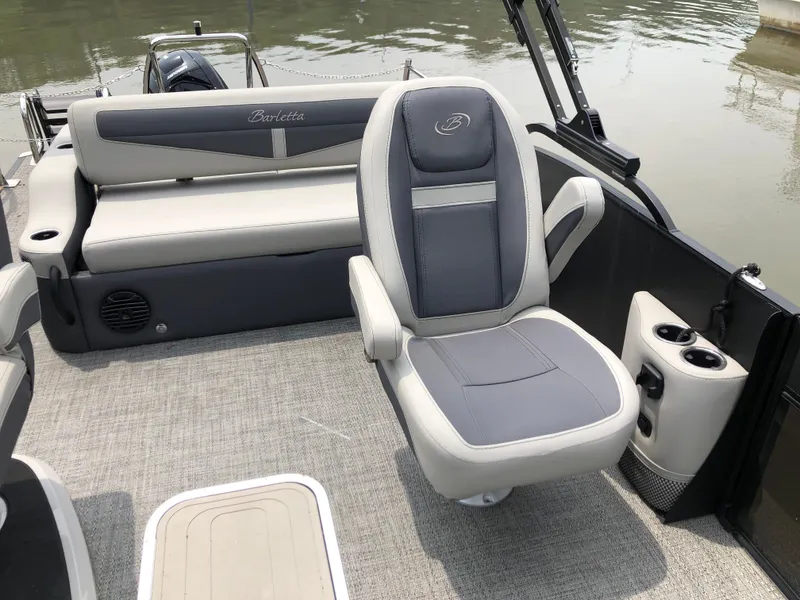 Slide: The Image of 2024 Barletta Cabrio 22UC boat interior with gray seating and cup holders. - 3