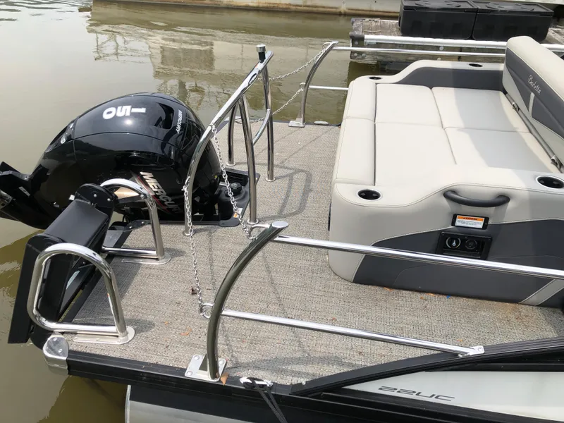 Slide: The Image of 2024 Barletta Cabrio 22UC pontoon boat with outboard motor and spacious seating. - 5