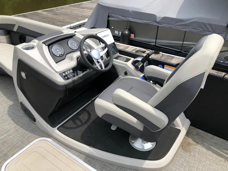 Slide: The Image of 2024 Barletta Cabrio 22UC boat helm with steering wheel and control panel. - 6