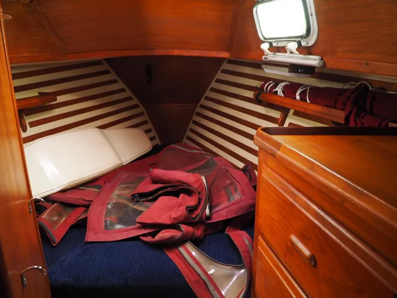 Slide: The Image of Cozy cabin interior of 1984 Endeavour 33 sailboat with wooden finish and nautical gear. - 22
