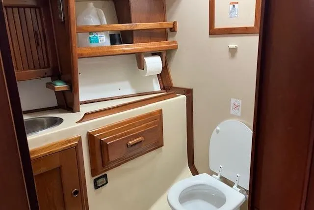 Slide: The Image of 1984 Endeavour 33 yacht bathroom with wooden cabinetry and compact design. - 28