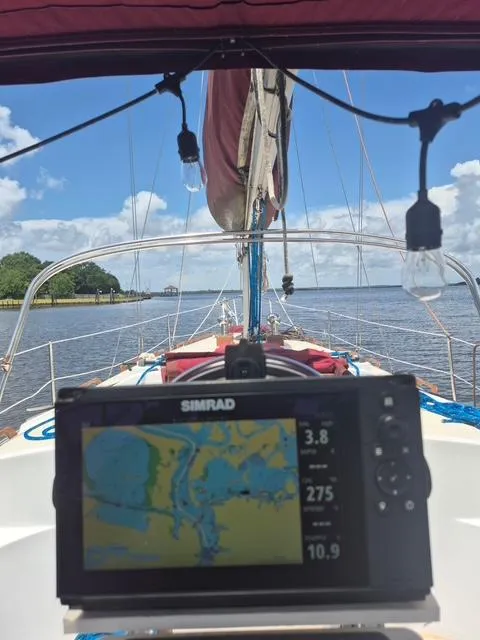 Slide: The Image of Sailing on 1984 Endeavour 33 with navigation display, clear skies, and calm waters. - 6