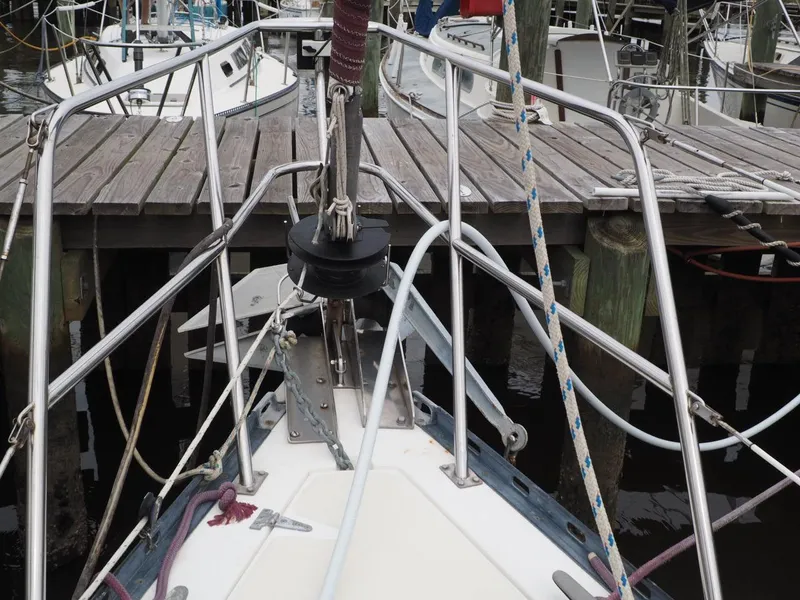 Slide: The Image of Bow of 1984 Endeavour 33 sailboat docked at a marina with wooden pier. - 8
