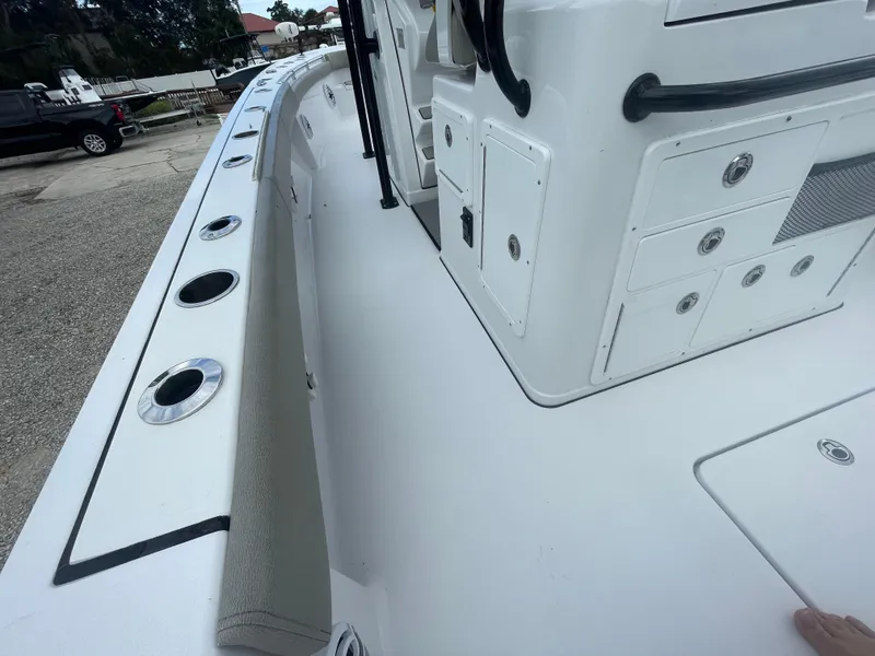 Slide: The Image of 2022 Sportsman Masters 267OE Bay Boat deck with rod holders and storage compartments. - 12