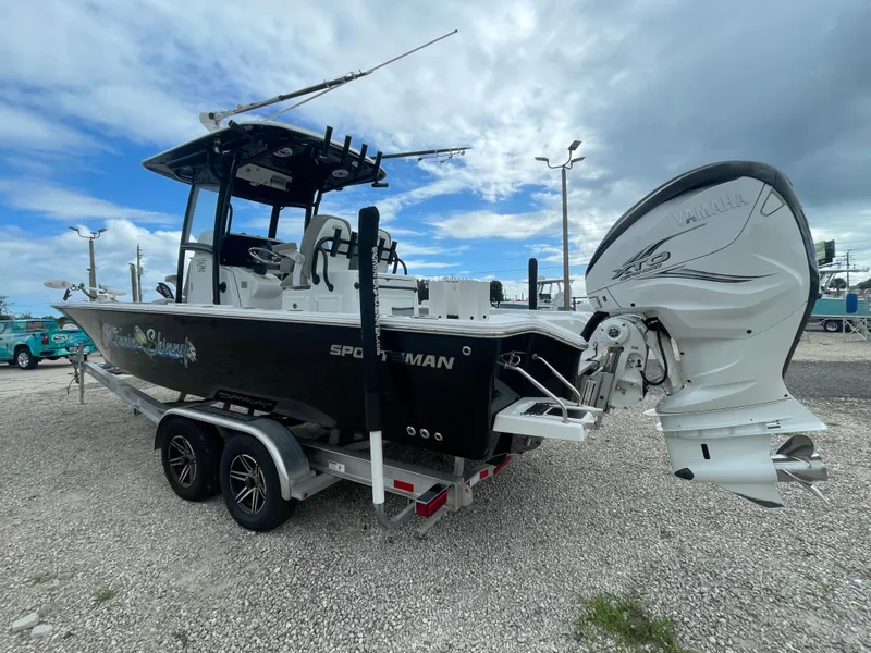 Slide: The Image of 2022 Sportsman Masters 267OE Bay Boat on trailer, featuring Yamaha outboard motor. - 2