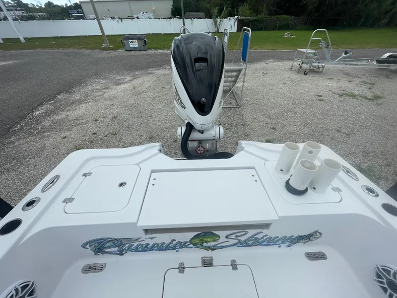 Slide: The Image of 2022 Sportsman Masters 267OE Bay Boat with outboard motor, docked on gravel. - 7