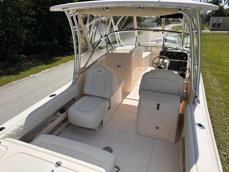 Slide: The Image of 2011 Grady-White Freedom 275 boat interior with seating and steering console. - 13