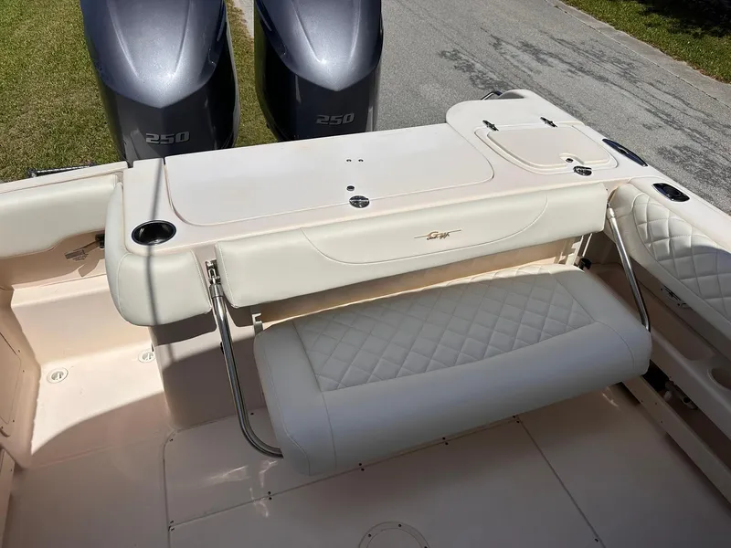 Slide: The Image of 2011 Grady-White Freedom 275 boat interior with seating and dual 250 engines. - 14