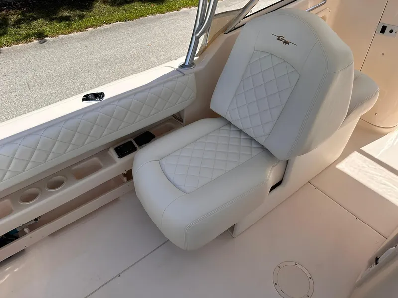 Slide: The Image of White leather seating on 2011 Grady-White Freedom 275 boat, featuring diamond stitching. - 18