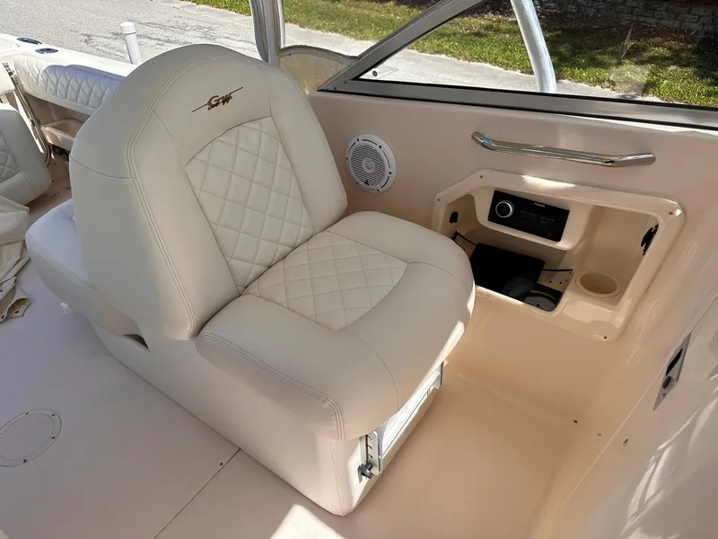 Slide: The Image of 2011 Grady-White Freedom 275 boat interior with cushioned seating and control panel. - 21