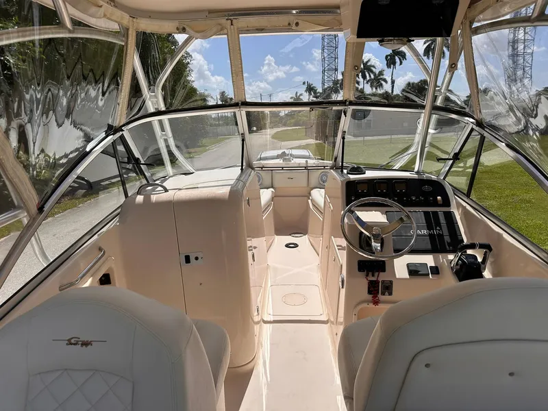 Slide: The Image of 2011 Grady-White Freedom 275 boat interior with steering wheel and seating. - 24