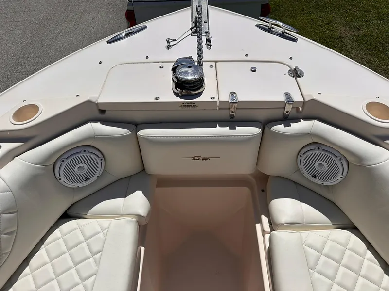 Slide: The Image of 2011 Grady-White Freedom 275 boat interior with cushioned seating and speakers. - 27