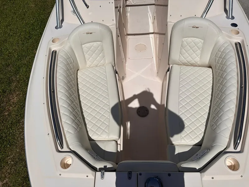 Slide: The Image of 2011 Grady-White Freedom 275 boat interior with white cushioned seating. - 28