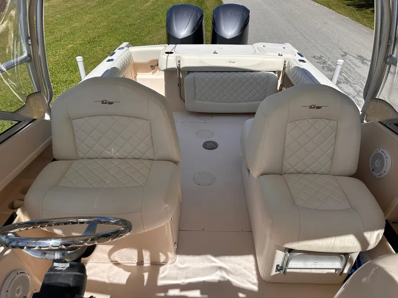 Slide: The Image of 2011 Grady-White Freedom 275 boat interior with dual seats and steering wheel. - 30