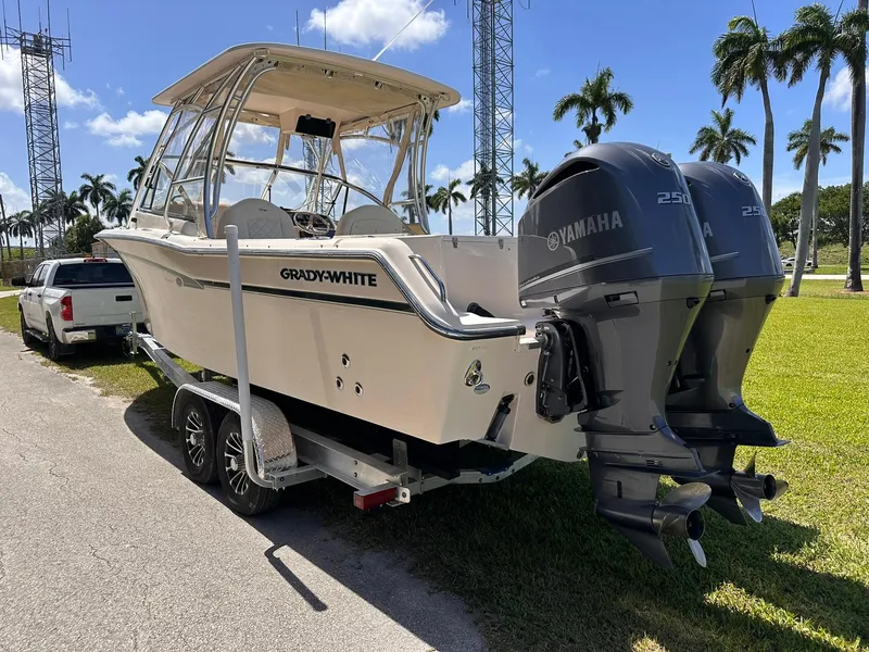 Slide: The Image of 2011 Grady-White Freedom 275 boat on trailer with twin Yamaha engines, parked outdoors. - 5
