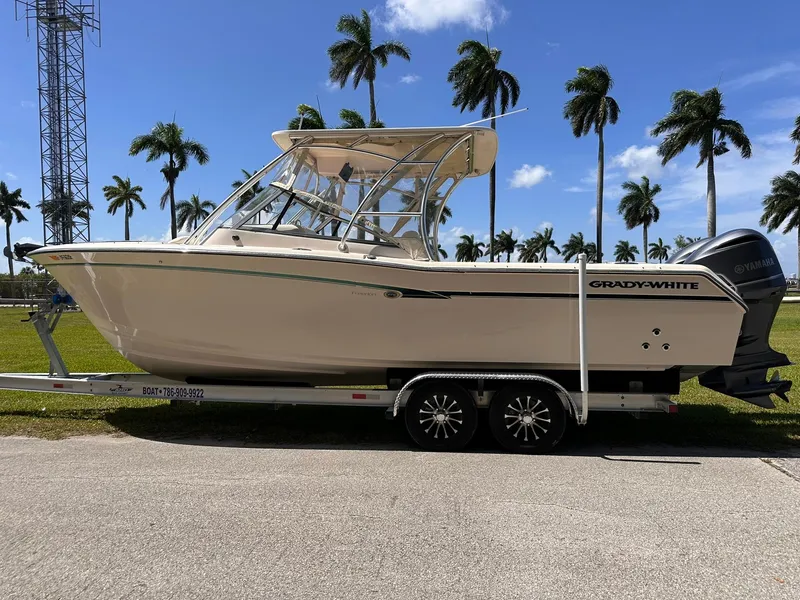 Slide: The Image of 2011 Grady-White Freedom 275 boat on trailer, palm trees in background. - 6