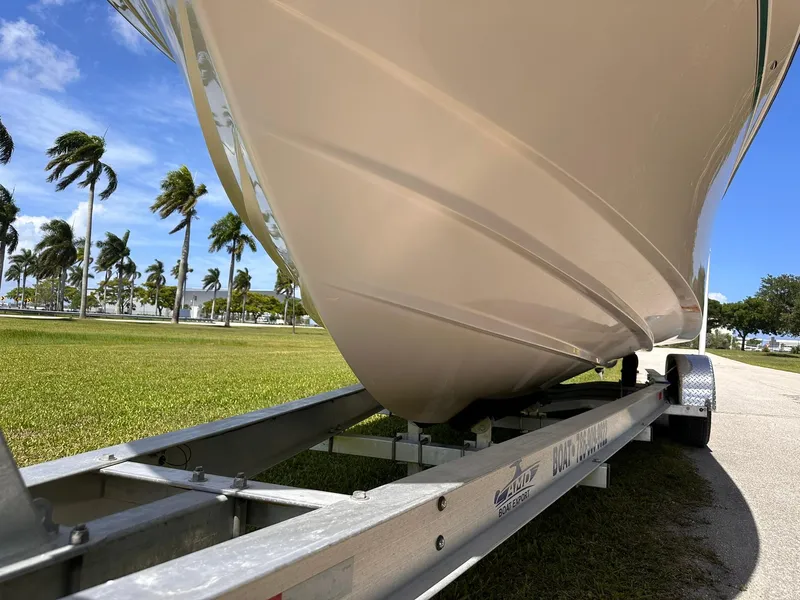 Slide: The Image of 2011 Grady-White Freedom 275 boat on trailer, sunny day, palm trees in background. - 9