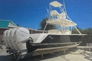 The Image of 2008 SeaVee 390B boat with multiple outboard engines, docked on land. - 0