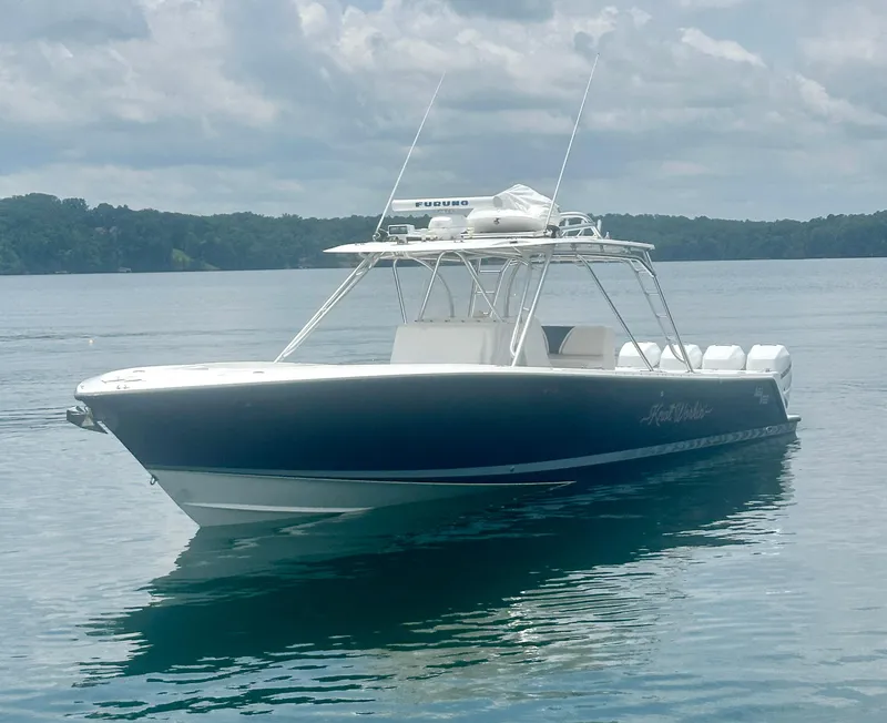 Slide: The Image of 2008 SeaVee 390B boat on calm water under cloudy sky. - 12