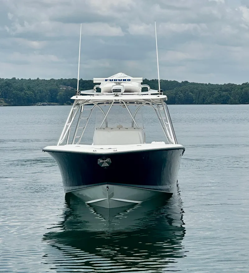 Slide: The Image of 2008 SeaVee 390B boat on calm water, front view, under cloudy sky. - 13