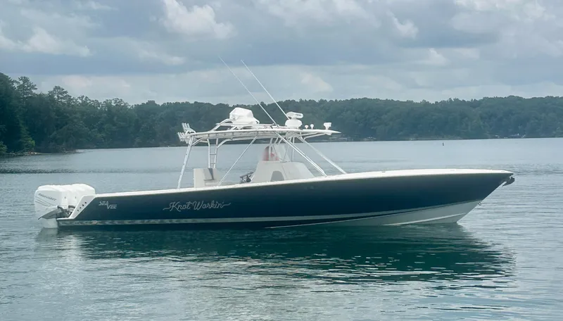 Slide: The Image of 2008 SeaVee 390B boat on calm water under cloudy sky. - 14