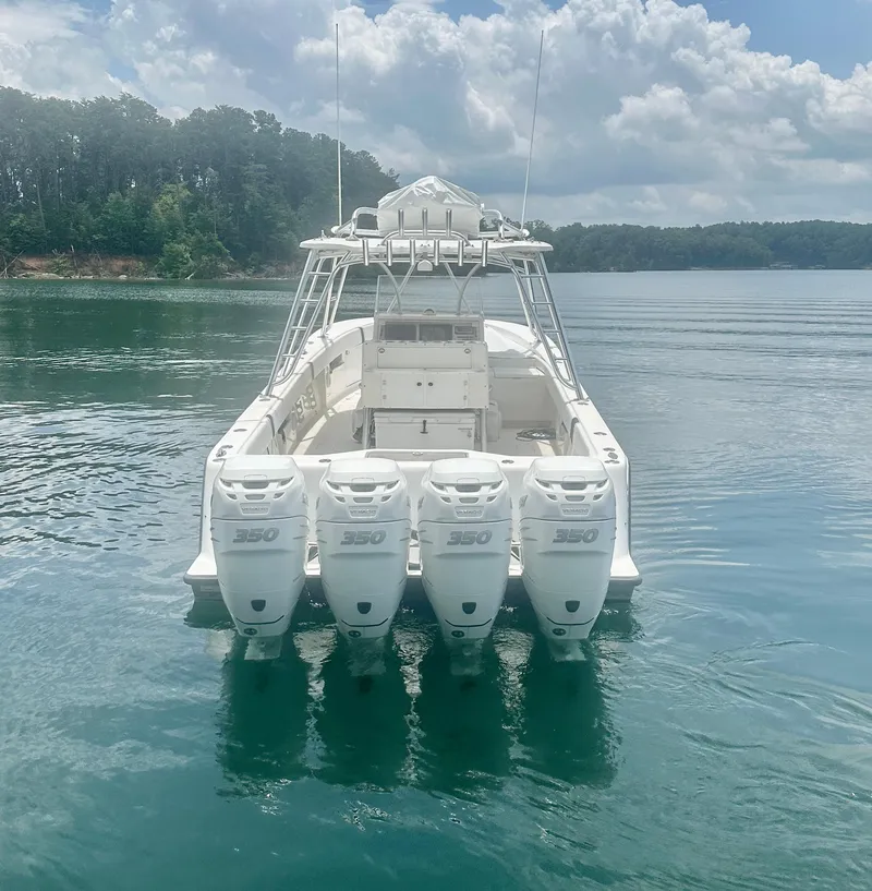 Slide: The Image of 2008 SeaVee 390B boat with four powerful engines on a calm lake. - 16