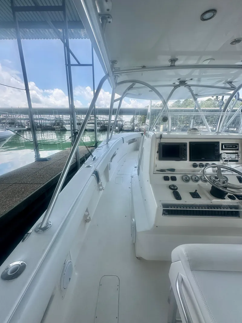 Slide: The Image of 2008 SeaVee 390B boat interior with helm, controls, and seating under a canopy. - 19