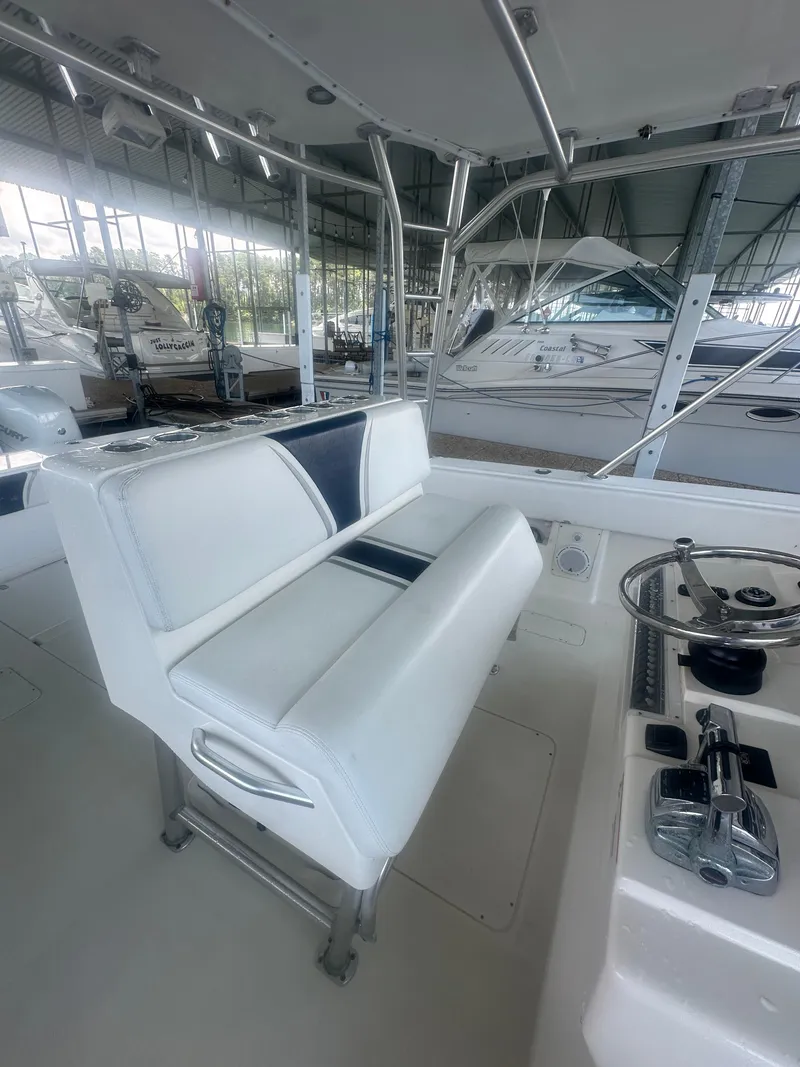 Slide: The Image of 2008 SeaVee 390B boat interior with white seating and steering console. - 21