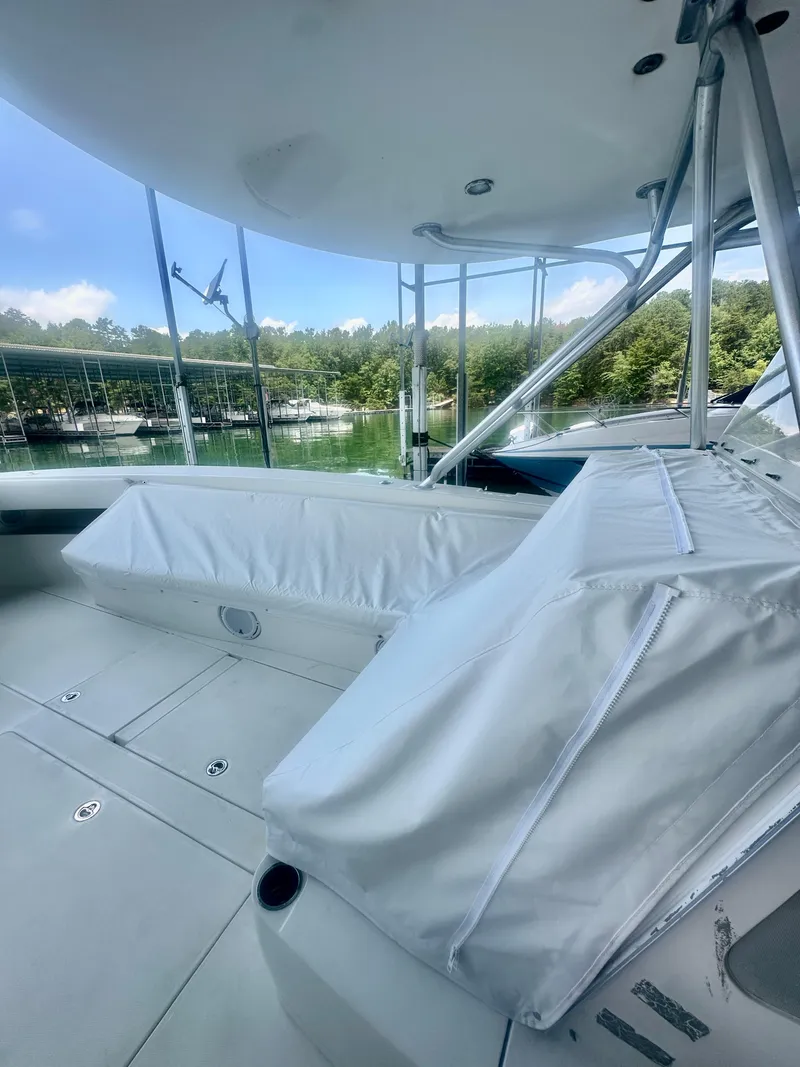 Slide: The Image of 2008 SeaVee 390B boat interior with covered seating and scenic lake view. - 24