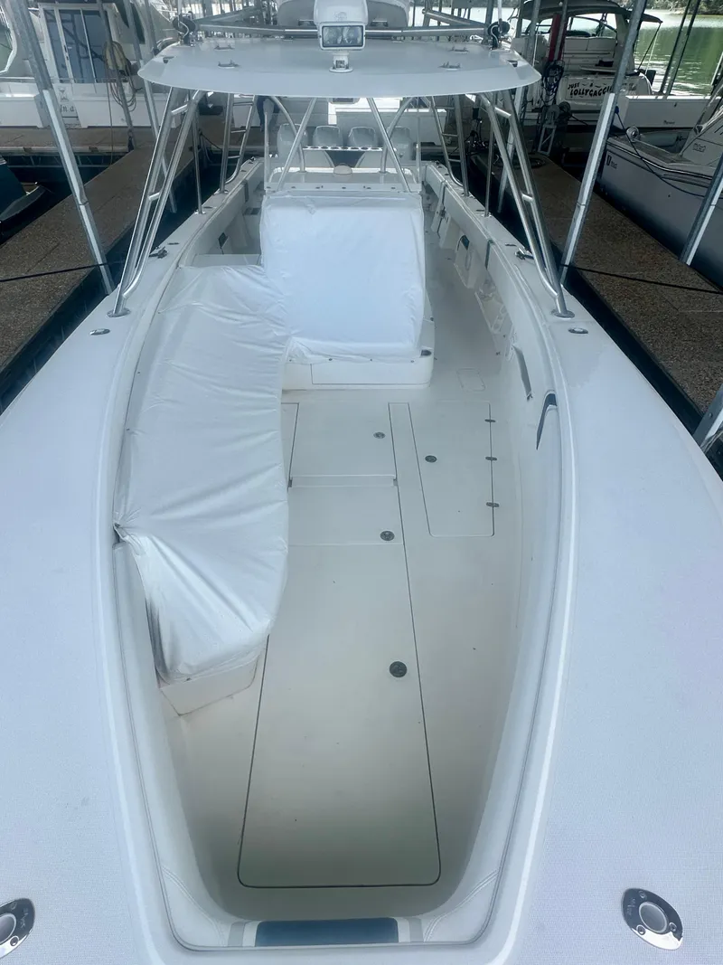 Slide: The Image of 2008 SeaVee 390B boat, spacious deck, white seating, and canopy. - 25