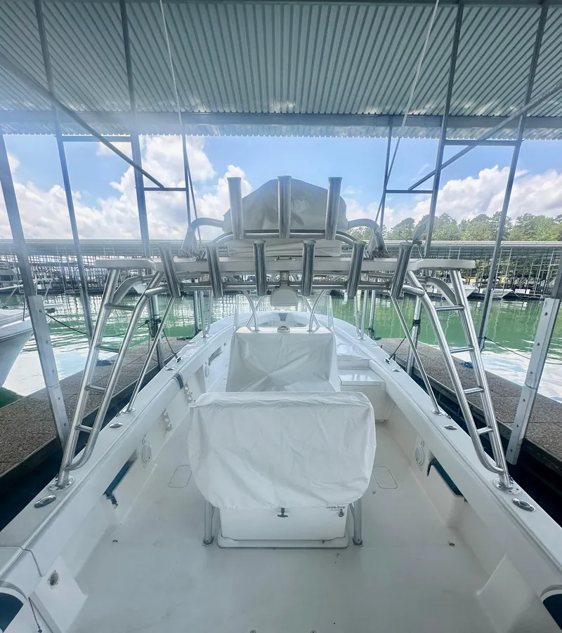 Slide: The Image of 2008 SeaVee 390B boat docked under a canopy with clear skies. - 31