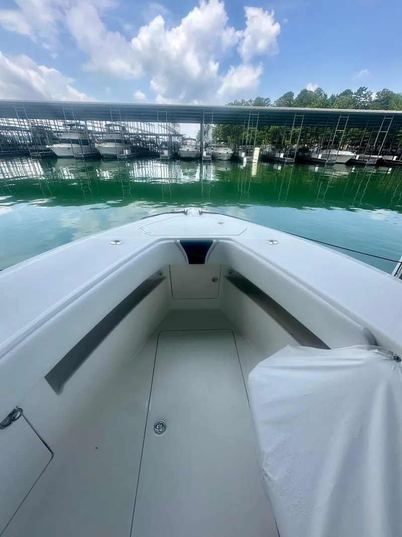 Slide: The Image of 2008 SeaVee 390B boat docked, showcasing spacious deck and serene marina backdrop. - 36