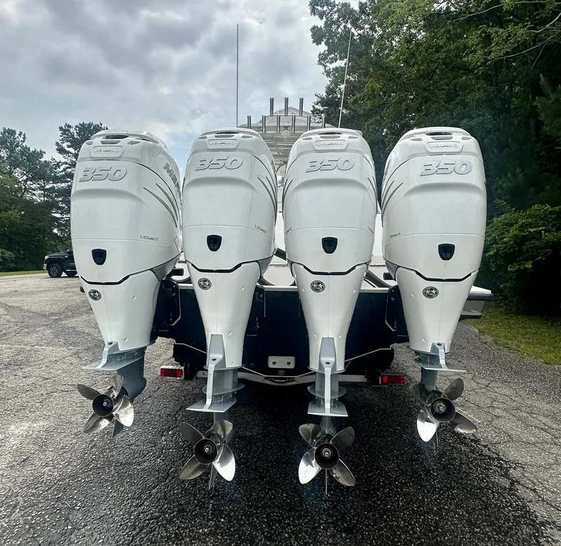 Slide: The Image of 2008 SeaVee 390B boat with four powerful outboard engines, parked outdoors. - 4
