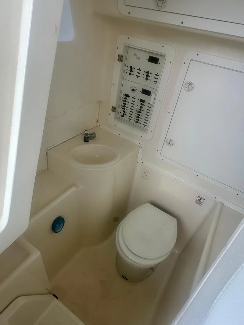 Slide: The Image of 2008 SeaVee 390B boat bathroom with toilet and control panel. - 40