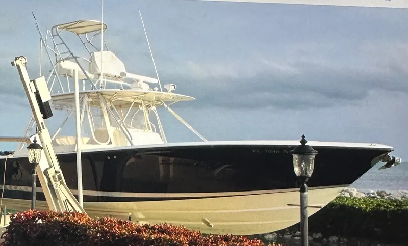 Slide: The Image of 2008 SeaVee 390B boat docked by the ocean under a cloudy sky. - 7
