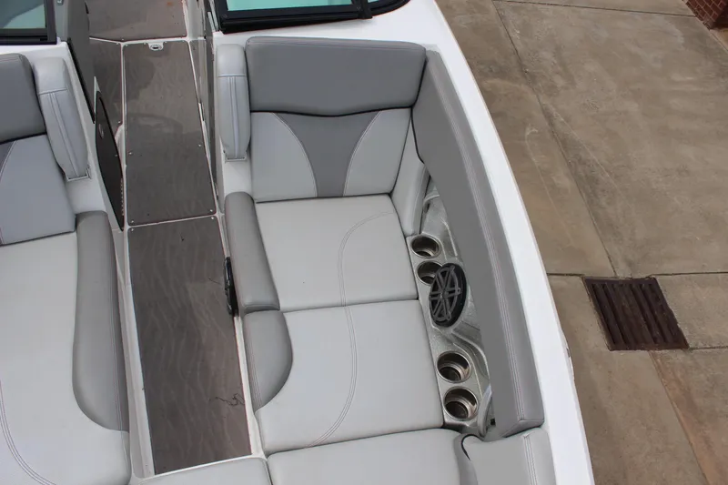 Slide: The Image of 2016 MasterCraft X26 boat interior with gray seating and cup holders. - 10