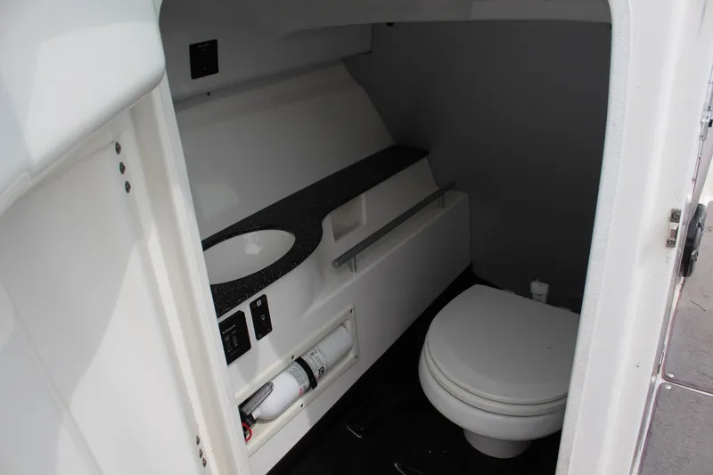 Slide: The Image of 2016 MasterCraft X26 boat interior bathroom with sink and toilet. - 12