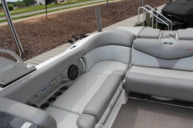 Slide: The Image of 2016 MasterCraft X26 boat interior with gray seating and cup holders. - 13