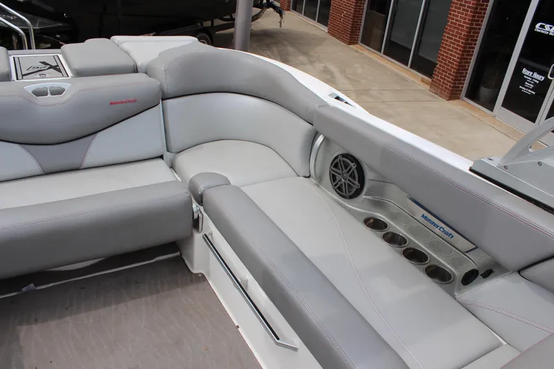 Slide: The Image of 2016 MasterCraft X26 boat interior with gray seating and cup holders. - 14