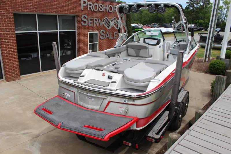 Slide: The Image of 2016 MasterCraft X26 boat at dealership, rear view with swim platform. - 5
