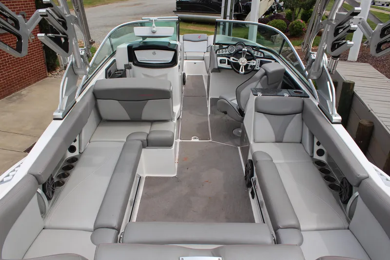 Slide: The Image of 2016 MasterCraft X26 boat interior with gray seating and modern dashboard. - 6